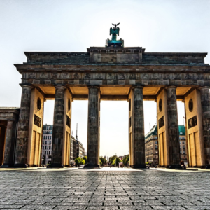 An image showcasing the iconic Brandenburg Gate with its neoclassical design, towering columns, and quadriga statue atop