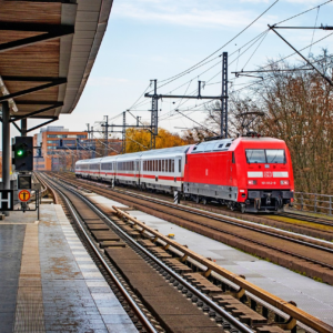 An image that visually represents the experience of riding on the S-Bahn in Berlin, showcasing the unique architecture and atmosphere of the train stations and the cityscape that passes by outside the windows